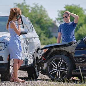 A car accident scene with a distressed man and a woman on her phone. Title about insurance in Arkansas.